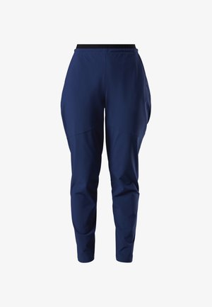 Marineblauwe taps toelopende broek met elastische tailleband en subtiele naaddetails, ontworpen voor comfort en casual gebruik.