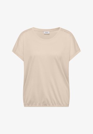 Blouse beige à manches courtes avec encolure ronde, ourlet élastique et coutures apparentes le long des coutures d'épaule, étiquetée "Cecil".