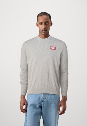 Light gray crewneck sweater made of soft fabric features a red Diesel logo patch on the left side, with ribbed cuffs and hem.
