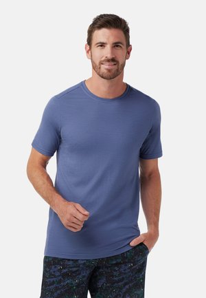 T-shirt à manches courtes col rond de couleur bleue unie, en tissu doux en mélange de coton, avec une coupe décontractée et une texture lisse.