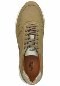 Light brown suede sneaker with round toe, textured laces, white sole, and orange interior. Features a logo tag near the heel.