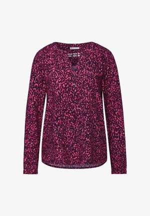 Langærmet top i mørk lilla med et pink abstract mønster, V-halsudskæring og knapdetaljer. Fremstillet i et let, tekstureret stof.