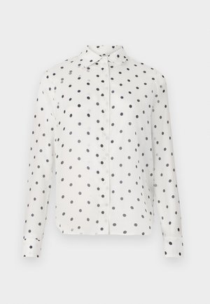 White button-up shirt with navy polka dots, featuring a classic collar and long sleeves. Made of smooth fabric, with button closures down the front.