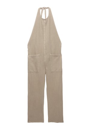 Beige overall lavet af blød stof, med halterneck-design, to forlommer og lige ben.