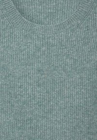 Stickad tröja i en mjuk, ljus teal-färg. Har en ribbad textur och en rund halsringning. Enkel och mångsidig design.