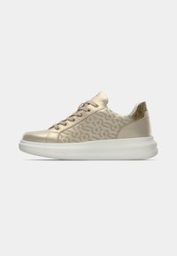 Gold sneakers with a patterned textile upper, metallic accents, and a chunky white sole. Features rounded toe and lace-up design.