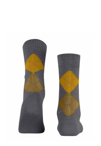 Calzini grigi con un motivo a diamante in giallo senape e marrone, con cuciture di accento rosa lungo i bordi dei diamanti. Materiale in misto cotone.