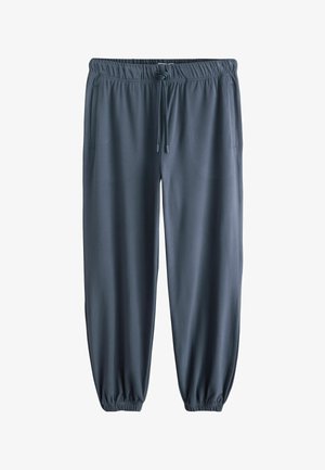 Mīkstas pelēkas sporta bikses ar elastīgu jostu un auklu, sānu kabatām un elastīgām aprocēm pie potītēm. Gluda tekstūra.