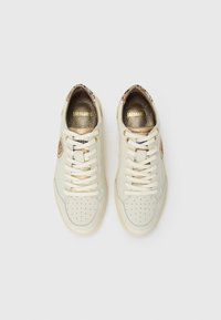 Pair of beige sneakers with perforated toes, white laces, and snake-skin textured brown accents on heels and sides, viewed from above.