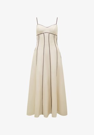 Kreemikas toon maxi kleit, millel on õhukesed rihmad, liibuv rinnaosa ja laienev seelik, millel on eristuv pruun vertikaalõmblus detailideks.