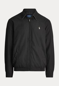 Giacca nera con zip, colletto, tasche laterali, vita elastica e piccolo logo Polo Ralph Lauren ricamato bianco sul petto.