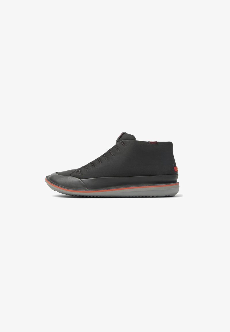 Black high-top sneaker with a smooth, matte finish, red accent line, and textured upper featuring spaced eyelets for laces.