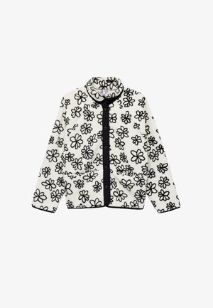 Veste en polaire avec une base blanche ornée de motifs floraux noirs, un col haut, des boutons noirs et deux poches avant. Tissu texturé.