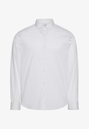 Bijela košulja dugih rukava, od pamuka, s gumbima. Ima standardni ovratnik, prednju preklopnicu s gumbima i zaobljeni rub. Suptilan logotip brenda.