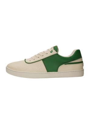 Low-top sneaker with beige perforated toe and sole, green side panel and heel, beige laces, and padded collar on a white background.