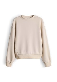 Light beige oversized sweatshirt with dropped shoulders, ribbed cuffs, and hem, made from soft fabric with a smooth texture.