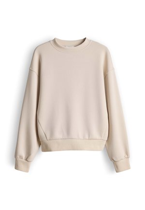 Licht beige oversized sweatshirt met verlaagde schouders, geribbelde manchetten en zoom, gemaakt van zachte stof met een gladde structuur.