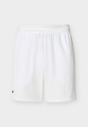 Λευκό αθλητικό σορτς με ελαστική μέση και μικρό πράσινο λογότυπο κροκόδειλου κοντά στο αριστερό κάτω τελείωμα.