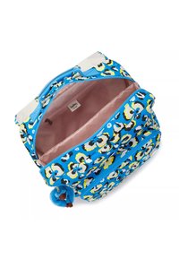 Blue floral-patterned backpack with pink lining, dual zippers, and a fluffy keychain accent. Features textured fabric and multiple compartments.
