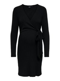 Robe de maternité noire côtelée avec manches longues et un design portefeuille, ornée d'un lien latéral et d'une silhouette ajustée. Texture douce.