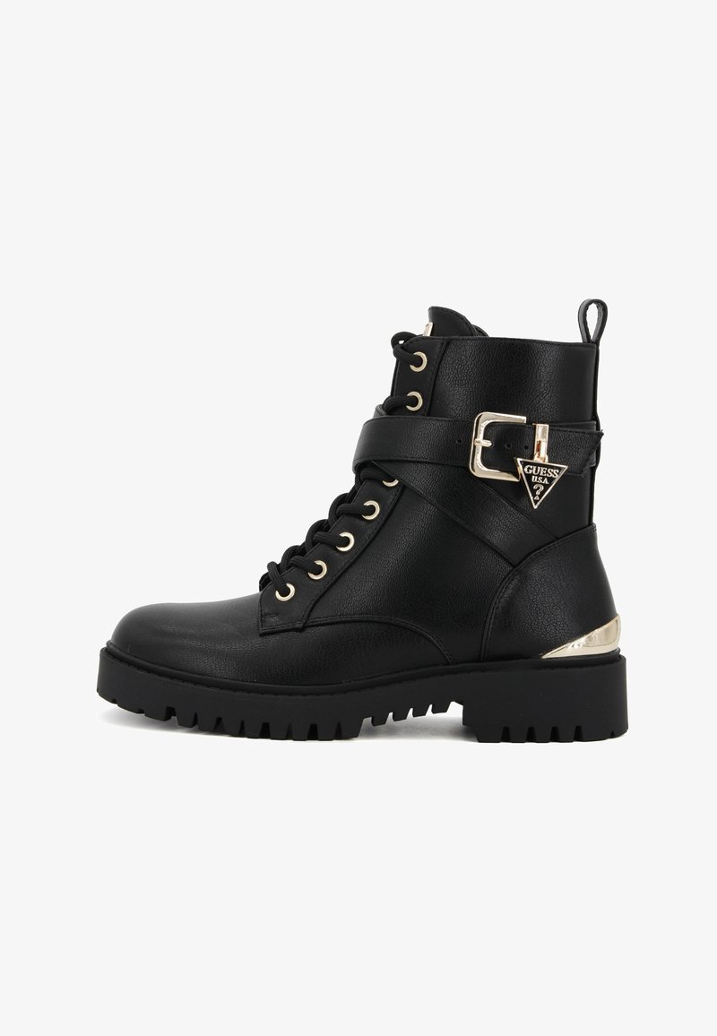 Bottine noire en cuir avec lacets, semelle épaisse, bride à boucle sur le côté et pendentif logo métallique Guess USA sur le talon.