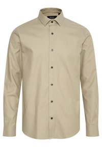 Ljus beige långärmad skjorta med knapp-ner krage, strukturert tyg och bruna knappar. Rakt skuren nederkant och justerbara manschetter.