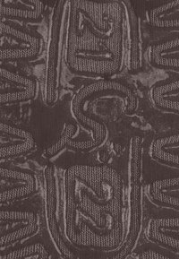 Textured fabric featuring woven patterns, showing numbers and letters in a dark color scheme. Material has a ribbed appearance.