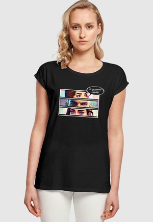 Schwarzes Baumwoll-T-Shirt mit kurz gerollten Ärmeln, versehen mit einem grafischen Druck von Augen in Feldern, und einer Sprechblase, die fragt: "Denkst du das Gleiche wie ich?"