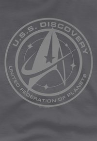 Navy blue fabric featuring a graphic design of the U.S.S. Discovery logo with circular text and star accents in light gray.