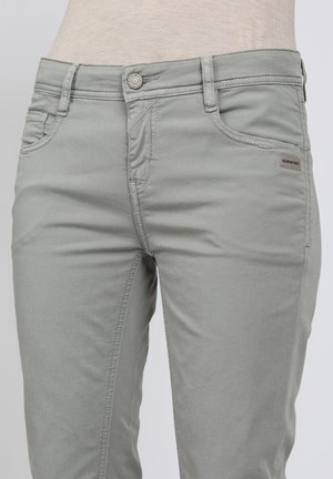 Light grey denim jeans with a slim fit, featuring front pockets, a button closure, and a small brand tag on the waistband.