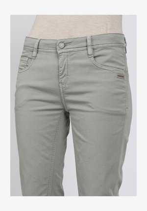 Light grey denim jeans with a slim fit, featuring front pockets, a button closure, and a small brand tag on the waistband.
