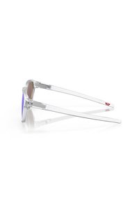 Occhiali da sole trasparenti con lenti a gradiente viola, caratterizzati da un design elegante e minimalista e bracci flessibili. Accenti con logo sui gambetti.