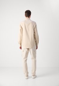 Tommy Jeans SHIRT - Shirt - newsprint