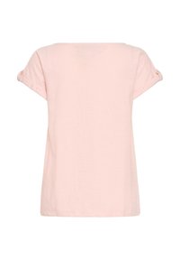 Chemise à manches courtes rose clair avec manches retroussées maintenues par des boutons, vue de dos sur fond blanc.