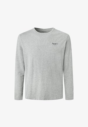 Heledhalli pikkade varrukatega t-särk, mis on valmistatud pehmest puuvillast, ümarate kaelustega ja väike must logo vasakul rinnal.