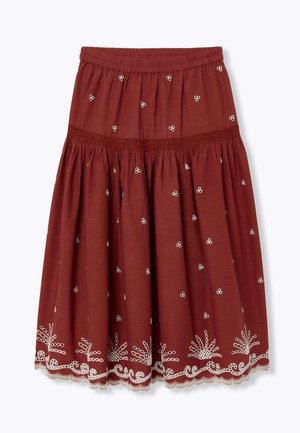 Jupe couleur rouille longueur genou avec motifs floraux brodés blancs et ourlet en dentelle festonné, dotée d'une ceinture élastique et de tissu froncé.