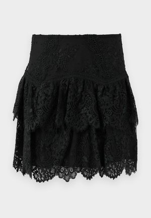 Black lace skirt featuring layered ruffles and intricate floral patterns. The hem has a scalloped edge for added texture and detail.