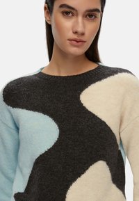Maglione in misto lana con scollo a girocollo, grandi motivi astratti in grigio scuro, blu pallido e crema, con una finitura texturizzata.