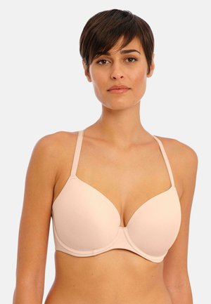 Light beige padded bra with adjustable straps, seamless design, and a smooth texture. Features a classic underwire for support.