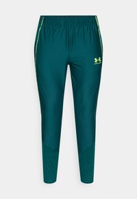 Τιρκουάζ αθλητικό παντελόνι με ελαστική μέση, κίτρινες ρίγες ως διακοσμητικό στοιχείο και υφασμάτινες επιφάνειες στα κάτω μέρη των ποδιών. Λογότυπο Under Armour στο ισχίο.