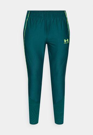 Modre športne hlače z elastičnim pasom, rumenimi poudarki v obliki črt ter teksturiranimi paneli na spodnjem delu nog. Logotip Under Armour na boku.