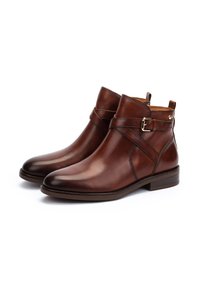Brown leather ankle boots with a smooth finish, featuring a strap and buckle detail, rounded toe, and low block heel.
