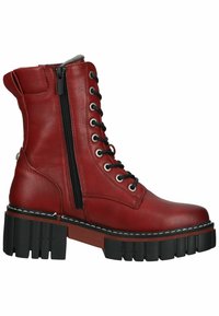Botines de cuero rojo con suelas de goma negra, que cuentan con una cremallera lateral, puntera redonda y cordones en la parte delantera. Suela gruesa y resistente con acentos en contraste.