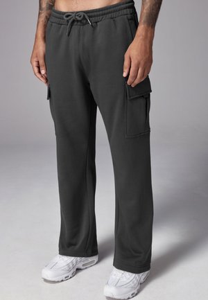Dark gray cargo pants made of soft fabric, featuring an elastic waistband with drawstring, side pockets, and a relaxed fit.