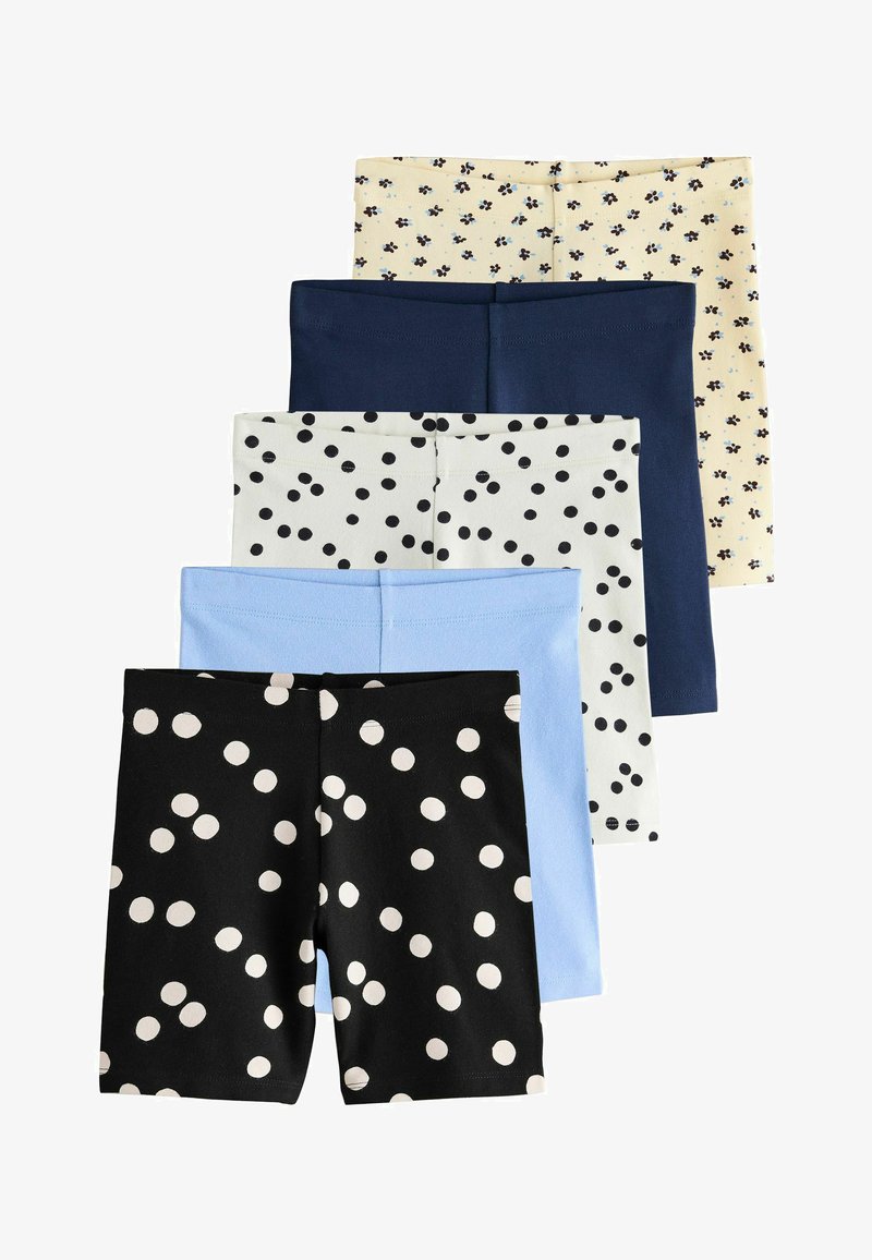 Cinq paires de shorts pliés empilés, avec des motifs comprenant du noir à pois blancs, du bleu clair, du blanc à pois noirs, du bleu marine et du crème à petits imprimés floraux.