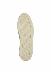 Semelle de chaussure en caoutchouc beige avec un motif hexagonal texturé, avec un logo en relief et des zones latérales renforcées pour une meilleure adhérence et durabilité.