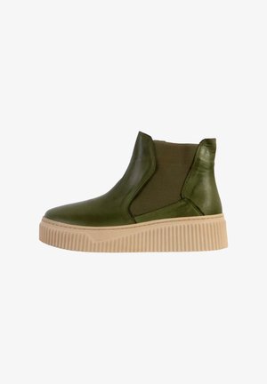 Bottine en cuir vert avec des côtés élastiqués, une semelle crème texturée et un dessus lisse. Notable pour son design moderne sans lacets.