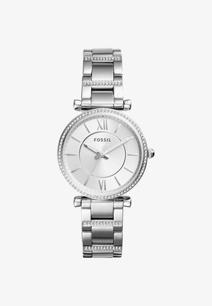 Reloj de pulsera Fossil plateado con esfera redonda, números romanos en el 12 y el 6, bisel adornado con cristales y pulsera de eslabones metálicos con detalles de cristal.