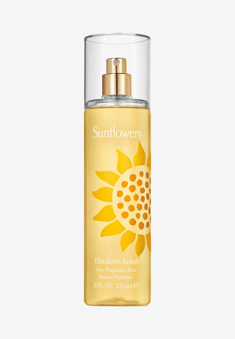 Bottiglia spray in vetro trasparente con hardware dorato e grafica di girasoli gialli. Contiene 236 ml di profumo per ambiente, etichettato 'Girasoli'.