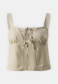 Crop top en lin beige clair avec lien ajustable à l'avant, larges bretelles et détail froncé sous la poitrine. Texture lisse.